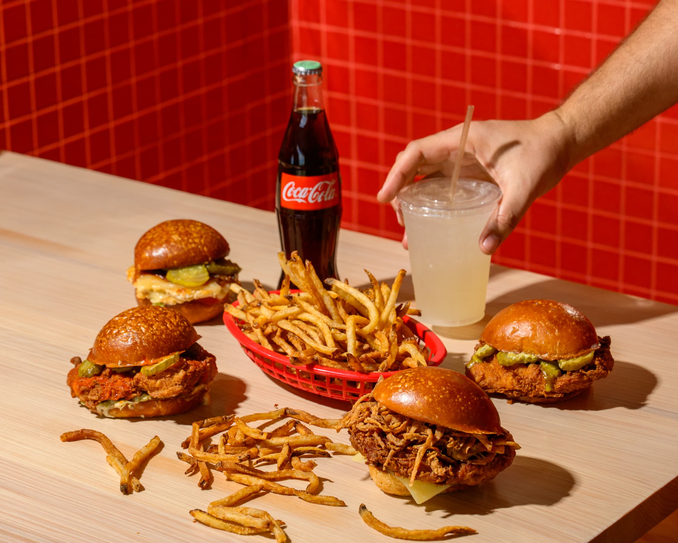 Full lineup of Pluma sandwiches with Coca-Cola, wide shot