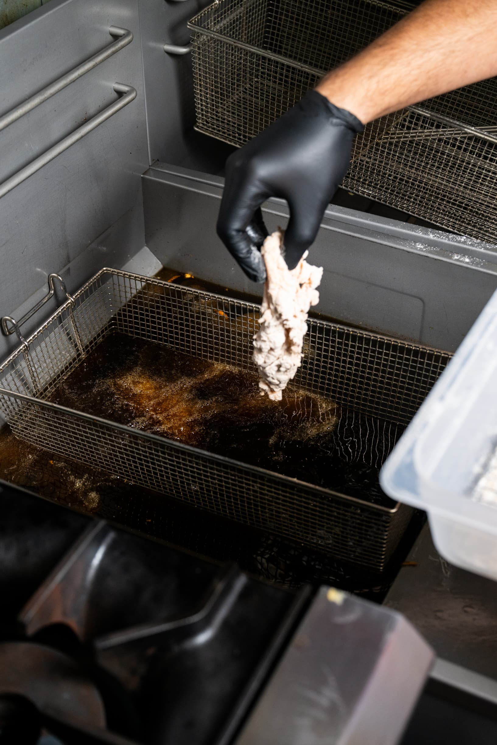 Chicken frying in sizzling beef tallow