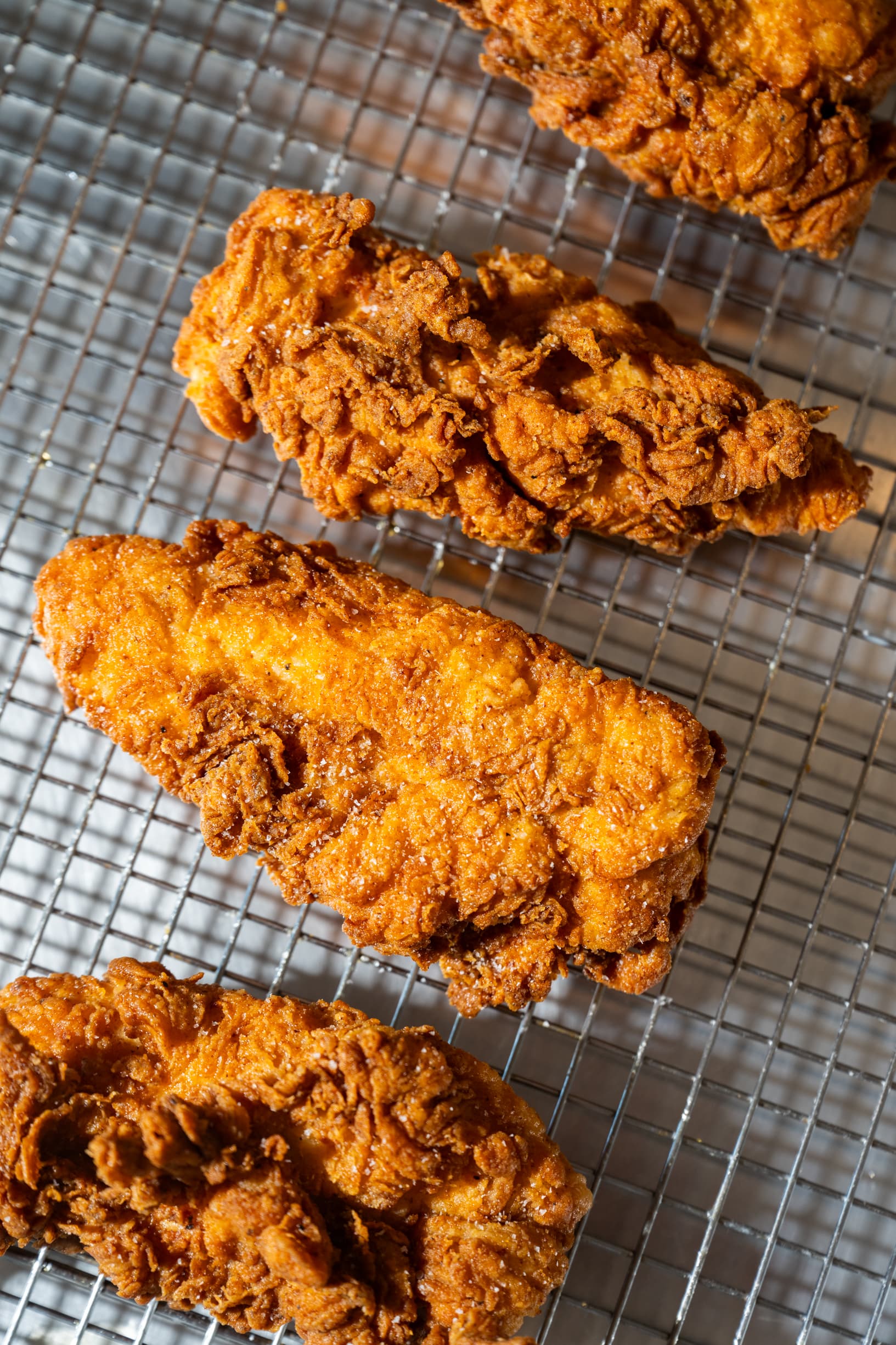 Crispy beef tallow fried chicken pieces on a serving tray