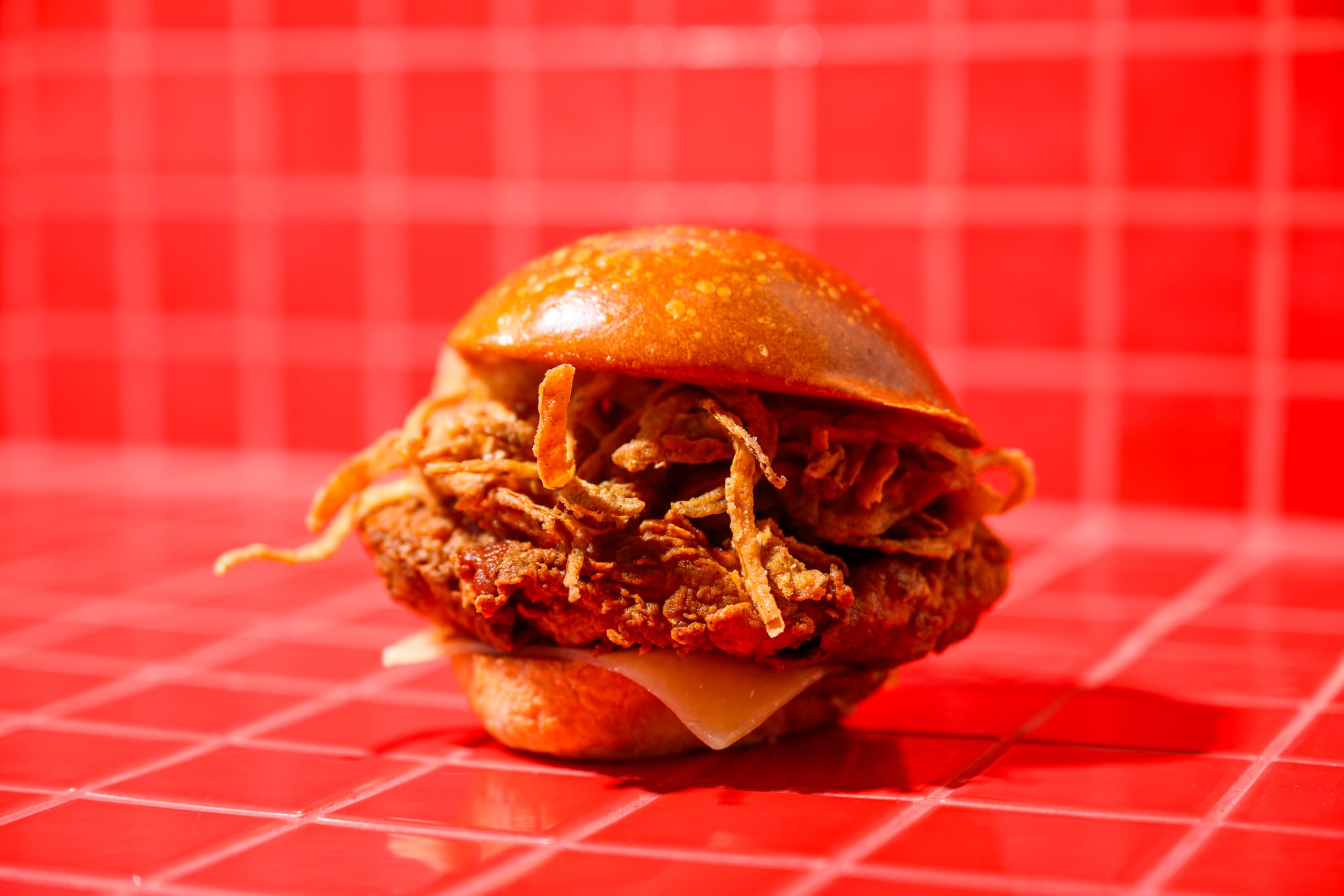 Tight close-up of a Pluma fried chicken sandwich cross-section