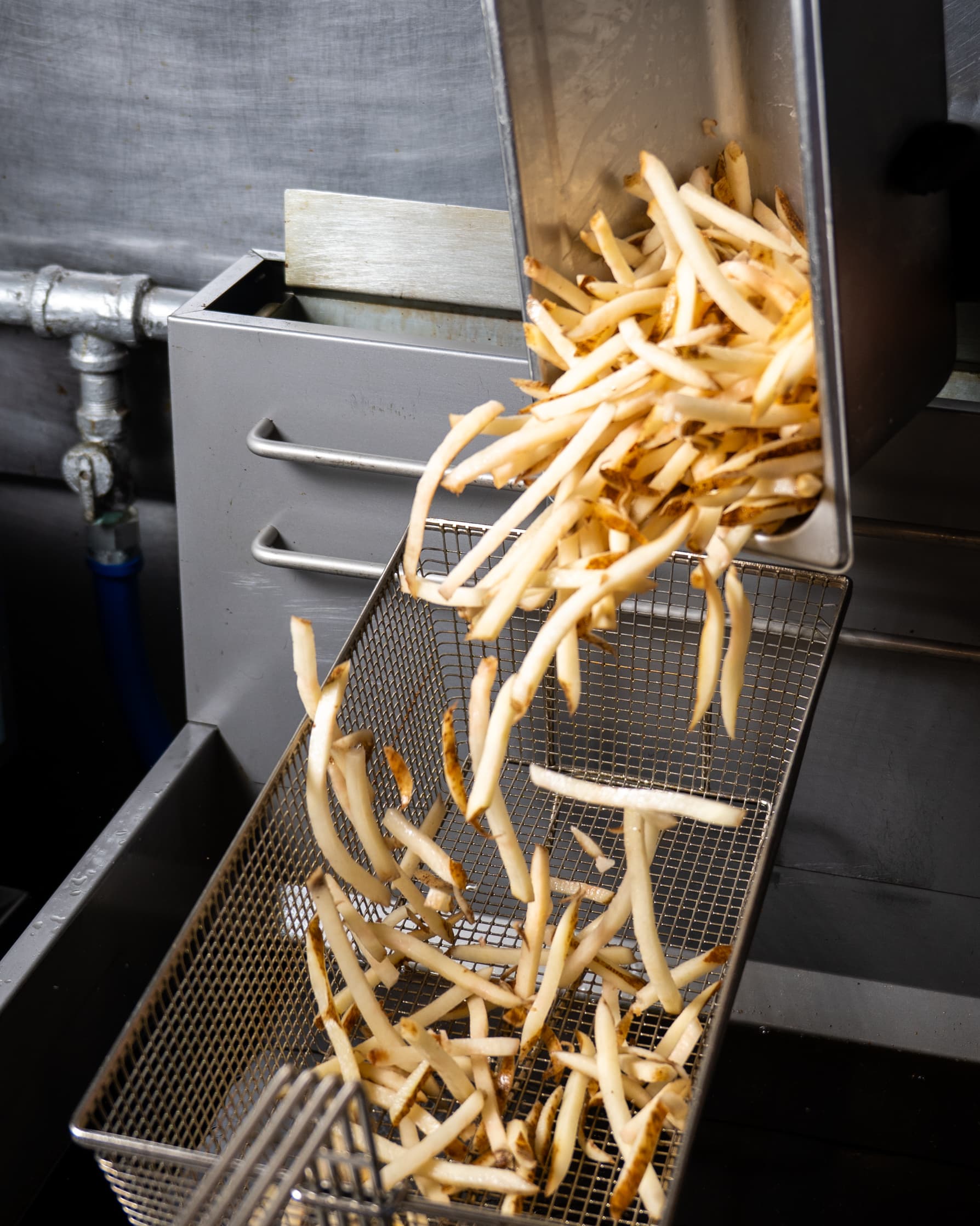 Perfectly golden beef tallow fries on the counter